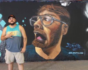 Garcia in front of his mural in the Netherlands